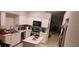 Functional kitchen with stainless steel appliances, white cabinetry, and a center island for meal preparation at 8419 Fort Thomas Way, Orlando, FL 32822