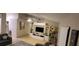 Spacious living room features tile flooring, a ceiling fan, and a built-in shelving unit for entertainment at 8419 Fort Thomas Way, Orlando, FL 32822