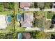 An aerial view shows the property's layout, showcasing its backyard pool and surrounding greenery at 8661 Crestgate Cir, Orlando, FL 32819