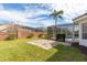 Charming backyard featuring a screened-in pool, brick perimeter, and well-manicured lawn at 8661 Crestgate Cir, Orlando, FL 32819