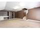 Finished basement with carpeted floor, staircase, and a custom built-in at 8661 Crestgate Cir, Orlando, FL 32819