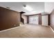 Finished basement with a door to the backyard features carpet and stairs to the upper level at 8661 Crestgate Cir, Orlando, FL 32819