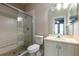 Bathroom with glass enclosed shower, neutral tile, and a white vanity at 8661 Crestgate Cir, Orlando, FL 32819