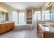 Bathroom features a tiled floor, dual vanities, and separate bathtub and shower at 8661 Crestgate Cir, Orlando, FL 32819