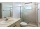 Cozy bathroom features a glass shower door and neutral tile at 8661 Crestgate Cir, Orlando, FL 32819