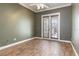 Bedroom with wood floors and a glass panel door leading to the outside at 8661 Crestgate Cir, Orlando, FL 32819