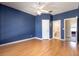 Bedroom showcases a ceiling fan and an open doorway with wood laminate flooring at 8661 Crestgate Cir, Orlando, FL 32819