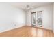 Bedroom featuring wood floors and glass panel doors leading to the outside at 8661 Crestgate Cir, Orlando, FL 32819