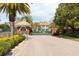 View of the gated entrance to the community with lush landscaping and brick-paved street at 8661 Crestgate Cir, Orlando, FL 32819