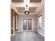 Dining room with hardwood floors, tray ceilings, modern lighting and window views at 8661 Crestgate Cir, Orlando, FL 32819