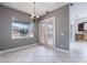 Dining area boasts tile floors, large windows, and elegant lighting fixtures at 8661 Crestgate Cir, Orlando, FL 32819