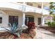 Close-up view of the home's entryway, showcasing manicured landscaping and columned porch at 8661 Crestgate Cir, Orlando, FL 32819