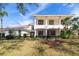 Attractive exterior of a home with a two-story porch with columns and landscaped yard at 8661 Crestgate Cir, Orlando, FL 32819