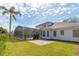 Exterior backyard view of the home featuring a screened-in pool and an outdoor patio at 8661 Crestgate Cir, Orlando, FL 32819