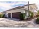 Side view of a house with a three-car garage and a brick-paved driveway and walkway at 8661 Crestgate Cir, Orlando, FL 32819