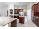 Well-appointed kitchen with granite countertops, custom cabinetry, and stainless appliances at 8661 Crestgate Cir, Orlando, FL 32819