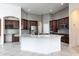 Open kitchen features custom cabinets, a center island, and stainless appliances at 8661 Crestgate Cir, Orlando, FL 32819