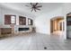 Spacious living room with a ceiling fan and a stylish stone fireplace feature at 8661 Crestgate Cir, Orlando, FL 32819