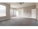 Bright living room with plush carpet, large windows, and double doors at 8661 Crestgate Cir, Orlando, FL 32819