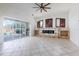 Bright living room with fireplace feature, pool view, and sliding glass doors at 8661 Crestgate Cir, Orlando, FL 32819