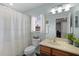 Bathroom with a shower and tub, vanity, mirror, and a window offering natural light at 9228 Cardinal Meadow Trl, Orlando, FL 32827