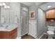 Bathroom shows a vanity with a sink, walk-in shower, toilet and storage cabinet at 9228 Cardinal Meadow Trl, Orlando, FL 32827