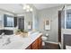 Bathroom featuring a double vanity, toilet, and glass-enclosed walk-in shower at 9228 Cardinal Meadow Trl, Orlando, FL 32827