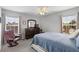 Bedroom with neutral walls, carpet, a blue quilt, and a comfortable chair at 9228 Cardinal Meadow Trl, Orlando, FL 32827