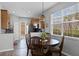 Dining area with hardwood floors, a modern chandelier, and a view of the backyard, perfect for casual dining at 9228 Cardinal Meadow Trl, Orlando, FL 32827