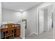 Hallway features a desk area with chair in the neutral-toned home at 9228 Cardinal Meadow Trl, Orlando, FL 32827