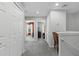 Hallway shows carpeted floors, white doors, and access to different rooms at 9228 Cardinal Meadow Trl, Orlando, FL 32827