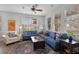 Bright living room with hardwood floors, stylish furniture, a decorative rug, and an abundance of natural light at 9228 Cardinal Meadow Trl, Orlando, FL 32827
