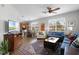 Comfortable living room showcasing hardwood floors, a large rug, and ample natural light from bright windows at 9228 Cardinal Meadow Trl, Orlando, FL 32827