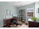 Office features a desk, chair, and bookshelf illuminated with natural light at 9228 Cardinal Meadow Trl, Orlando, FL 32827