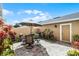 Outdoor patio area with brick pavers, seating, umbrella, and lush plants at 9228 Cardinal Meadow Trl, Orlando, FL 32827