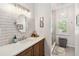 Bathroom features a vanity with a sink, a framed mirror, subway tile backsplash, and glass enclosed shower at 9686 Cypress Pine St, Orlando, FL 32827