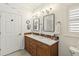 Bathroom featuring double vanity with marble countertops and custom mirrors at 9686 Cypress Pine St, Orlando, FL 32827