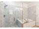 Modern bathroom with glass enclosed shower and separate soaking tub at 9686 Cypress Pine St, Orlando, FL 32827
