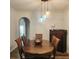 Dining area with modern lighting, hardwood floors, and adjacent door to the outside at 9686 Cypress Pine St, Orlando, FL 32827