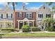 Charming townhome featuring a brick facade, manicured landscaping, and welcoming front porch at 9686 Cypress Pine St, Orlando, FL 32827
