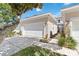 Beige two-story home with white garage door, walkway, and mature landscaping under a bright blue sky at 9686 Cypress Pine St, Orlando, FL 32827