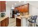 Beautiful kitchen with wood cabinets, granite countertops, and a cozy breakfast bar at 9686 Cypress Pine St, Orlando, FL 32827