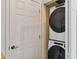 A stacked Whirlpool washer and dryer are located in a closet with white doors at 9686 Cypress Pine St, Orlando, FL 32827