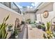 Charming courtyard with a fountain, comfortable seating, and lush potted plants creating a peaceful outdoor space at 9686 Cypress Pine St, Orlando, FL 32827