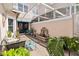 A screened in patio with brick pavers, a fountain, and plenty of seating at 9686 Cypress Pine St, Orlando, FL 32827