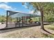 Community playground with slides, climbing structures, and benches under a shaded canopy at 9686 Cypress Pine St, Orlando, FL 32827