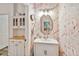 Fun powder room featuring flamingo wallpaper and new lighting at 9686 Cypress Pine St, Orlando, FL 32827