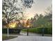 Picturesque walking path lined with manicured hedges and trees at sunset at 9686 Cypress Pine St, Orlando, FL 32827
