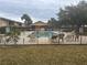 Community pool surrounded by lounge chairs and palm trees at 9916 Sweepstakes Ln # 1, Orlando, FL 32837