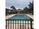 Community pool with lounge chairs and pool house at 9916 Sweepstakes Ln # 1, Orlando, FL 32837